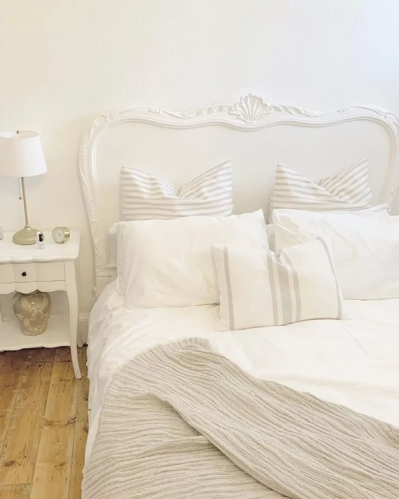 40 White Bedroom Designs That Show This Color Is Far from Dull 25 A White Bedroom With a Curved Headboard