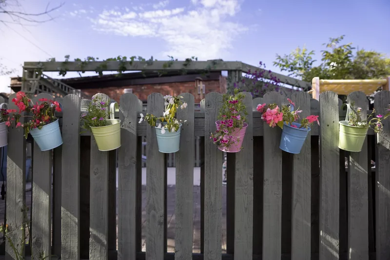 52 Wooden Fence Ideas Brimming with Rustic Outdoor Charm 6 Add Wooden Railing Planters