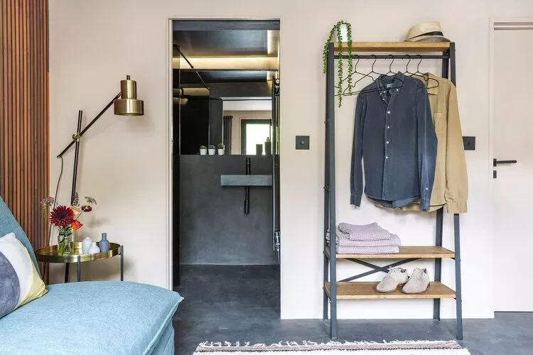 22 Guest Bedroom Ideas to Make the Most of Small Spaces 13 Add a Clothes Rack