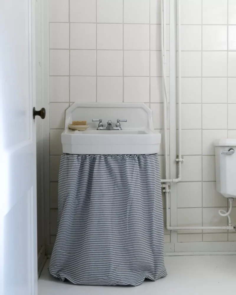 24 Basement Bathroom Design Ideas for Any Style & Budget 1 Add a Striped Sink Curtain