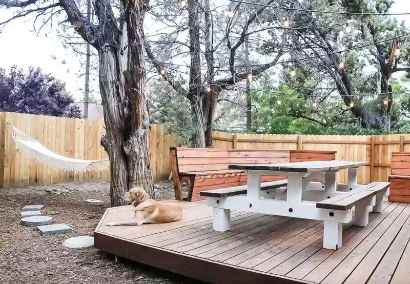 52 Wooden Fence Ideas Brimming with Rustic Outdoor Charm 2 Attach a Hammock to the Fence