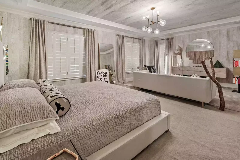 22 Calming and Expert-Approved Bedroom Layout Designs 19 Define a Lounge Space With an Area Rug