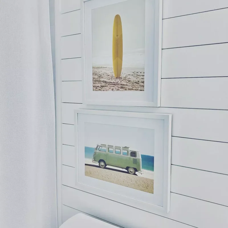 30 Beach-Inspired Bathroom Designs to Bring Coastal Vibes Home 1 Hang Coastal-Themed Art