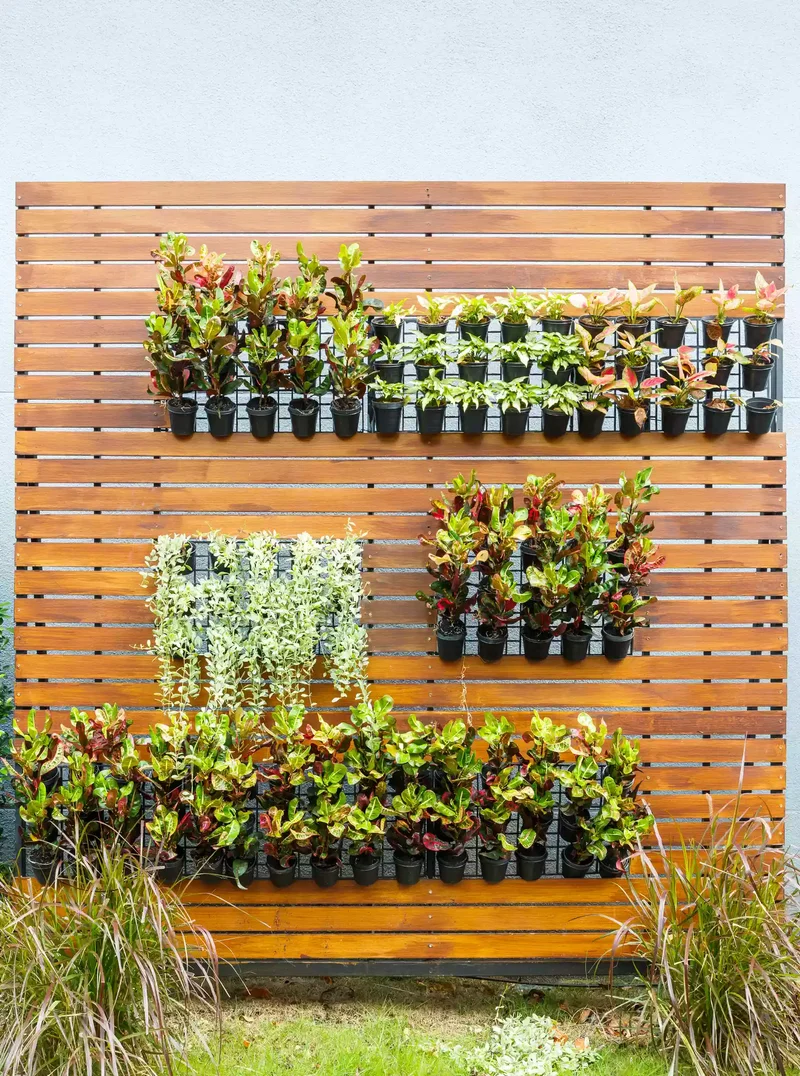 31 Creative Vertical Garden Designs for Your Home 5 Hang Small Planters on a Fence