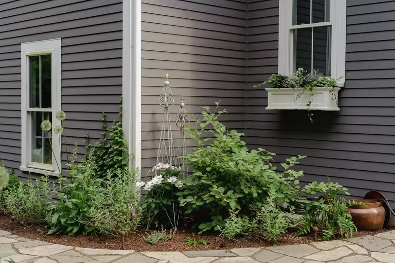 15 Clever Garden Hose Storage Solutions for Your Backyard 5 Hide It in a Lidded Hose Pot