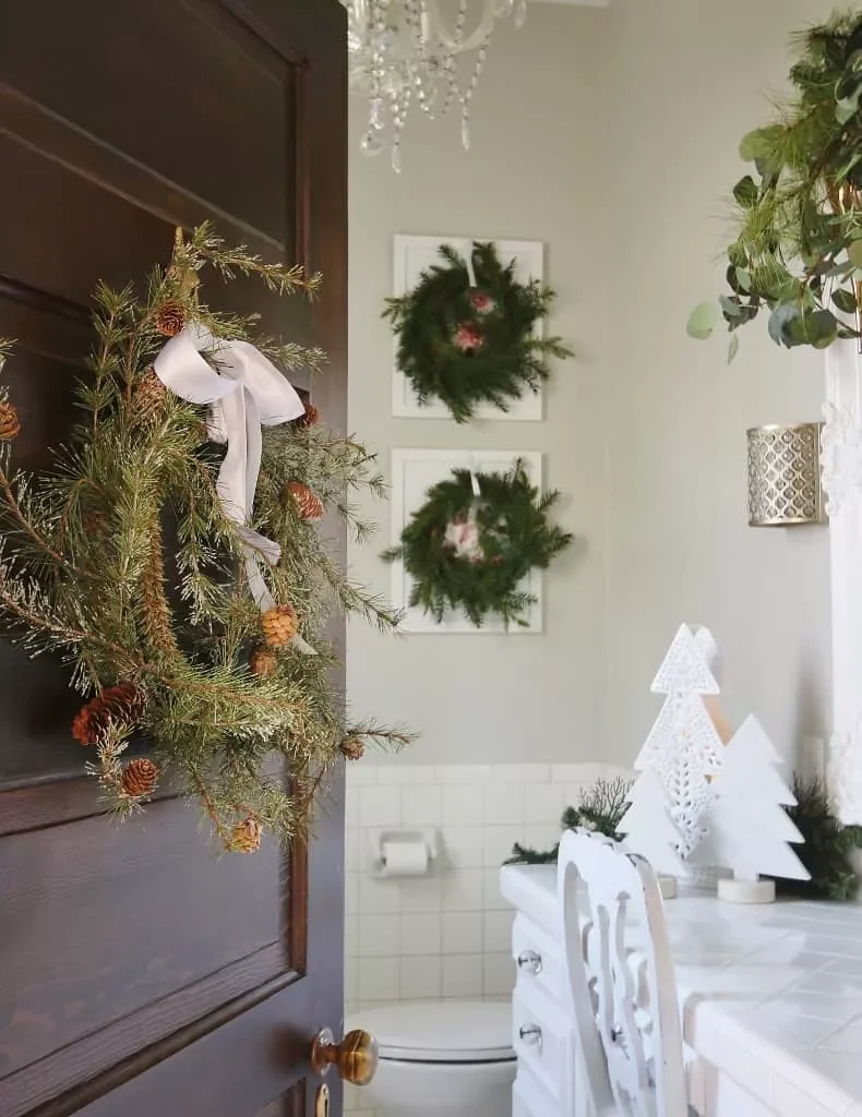 Decorating Your Bathroom for Christmas: 32 Festive Ideas 26 Layer Wreaths Over Art