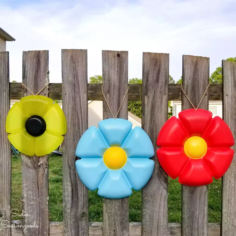 30 Creative Fence Decorating Ideas to Transform Your Yard 9 Make Sculptures From Repurposed Party Trays