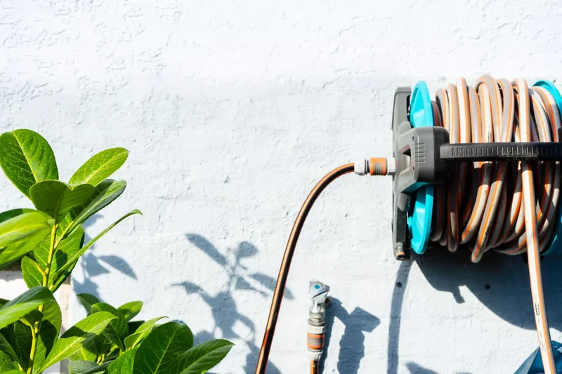 15 Clever Garden Hose Storage Solutions for Your Backyard 6 Mount a Hose Reel on the Wall