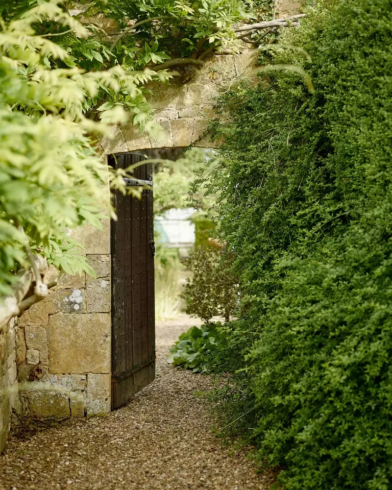 26 Secret Garden Ideas to Bring Your Favorite Books to Life 2 Pique Curiosity With a Wall and Door