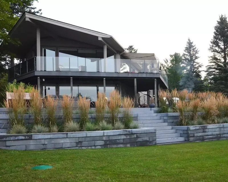 15 Sloped Backyard Solutions to Maximize Your Outdoor Space 3 Plant a Two-Tiered Garden