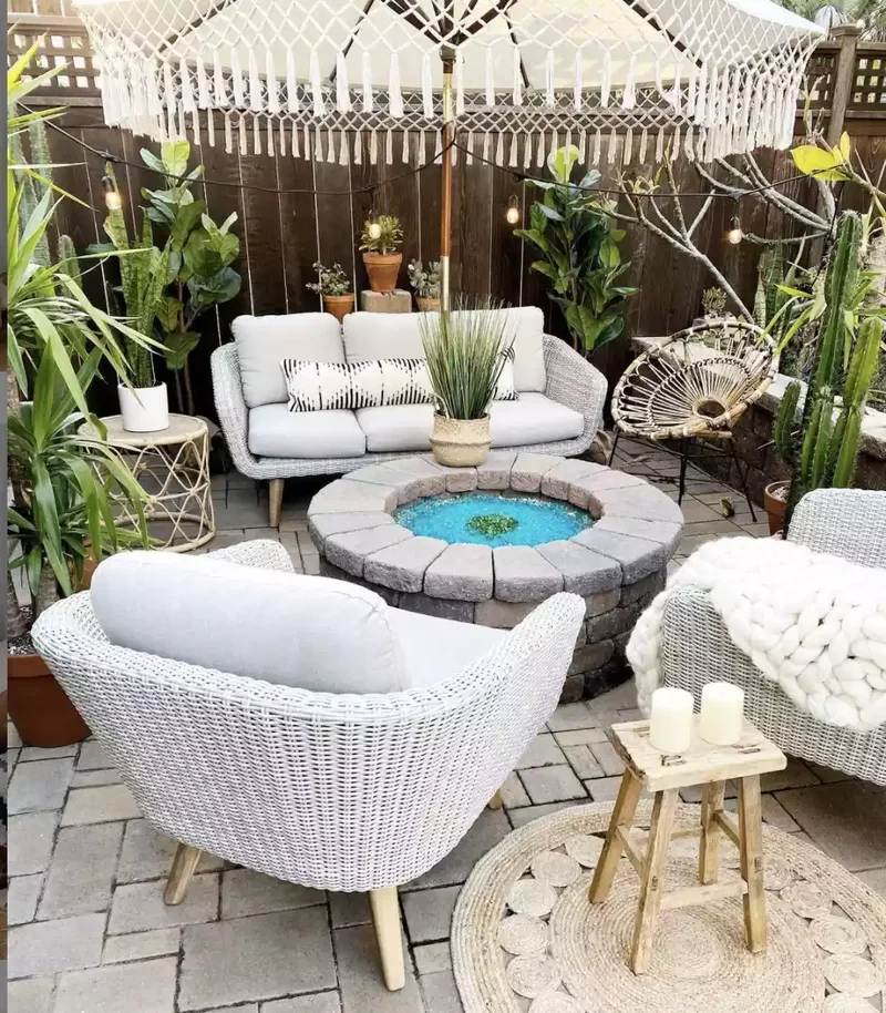 21 Rustic Stone Fire Pit Ideas for Your Outdoor Retreat 11 Stone Fire Pit Surrounded by Plant Oasis