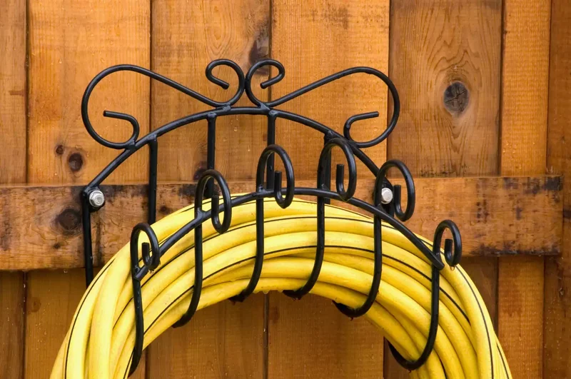 15 Clever Garden Hose Storage Solutions for Your Backyard 4 Use a Decorative Hanger