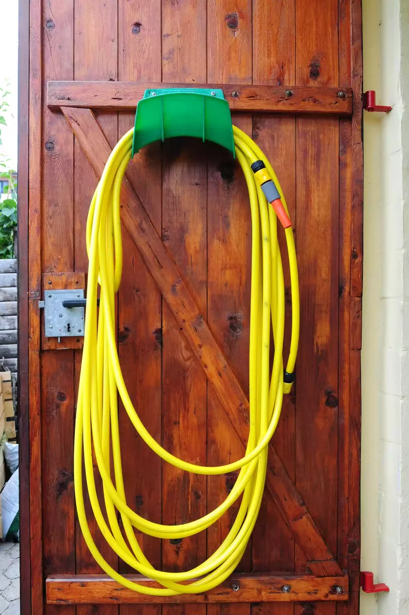 15 Clever Garden Hose Storage Solutions for Your Backyard 2 Utilize a Door