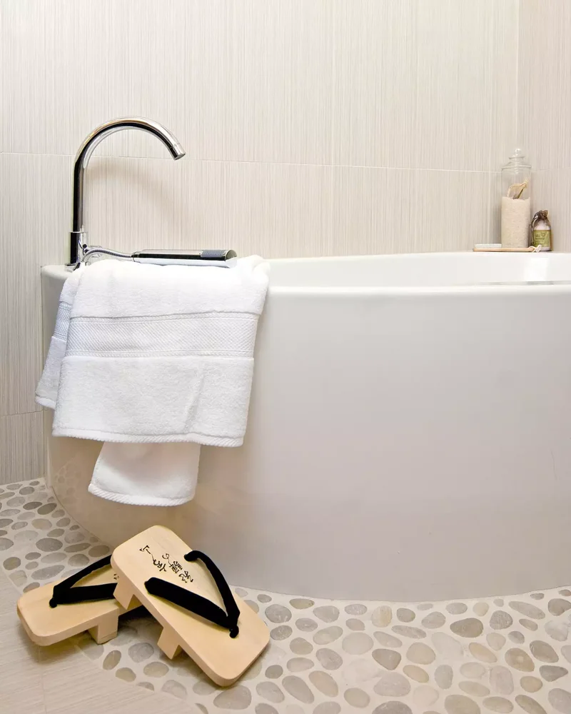 30 Designer Tips for Creating a Japandi Bathroom Retreat 30 White Pebble Floor