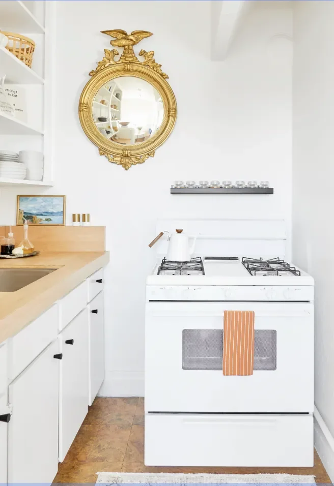 White and Gold Kitchen With Butcher Block Countertops